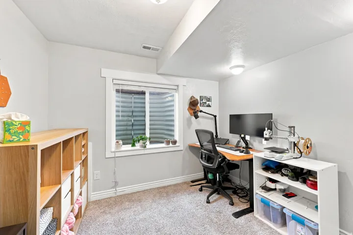 Recessed window with white trim, light gray painted walls, and textured carpet flooring
