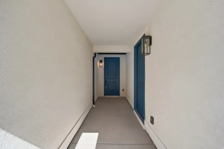 Stucco exterior with a painted blue door