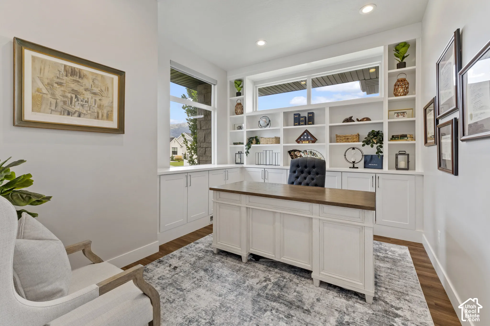 Built-in shelving with lower cabinetry, wood-finish flooring, recessed lighting, and a large window