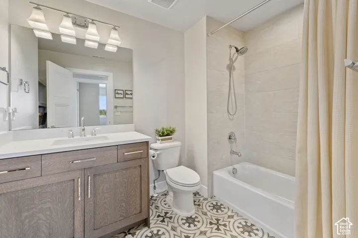 Contemporary bathroom featuring a wood-finish vanity with dual sinks, white quartz countertop, and polished chrome fixtures