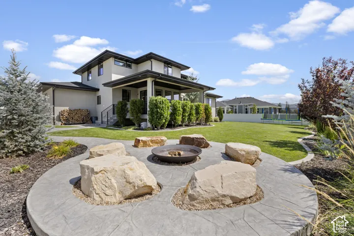 Modern two-story residence with contemporary architectural design, featuring a composite or stone-finish exterior with multi-level rooflines