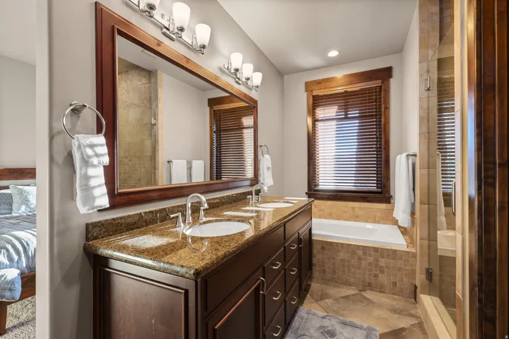 Middle Bedroom. Dual vanity with granite countertop, individual basin sinks, and dark wood cabinetry