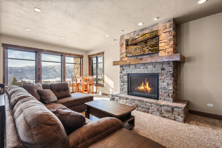 Stone-clad fireplace with a wood mantel
