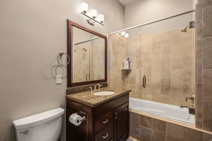 South bedroom. Dark wood-finish vanity with a light-toned countertop