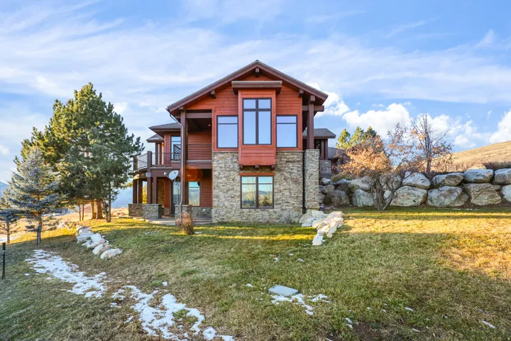 Multi-level facade featuring wood siding and stone accents