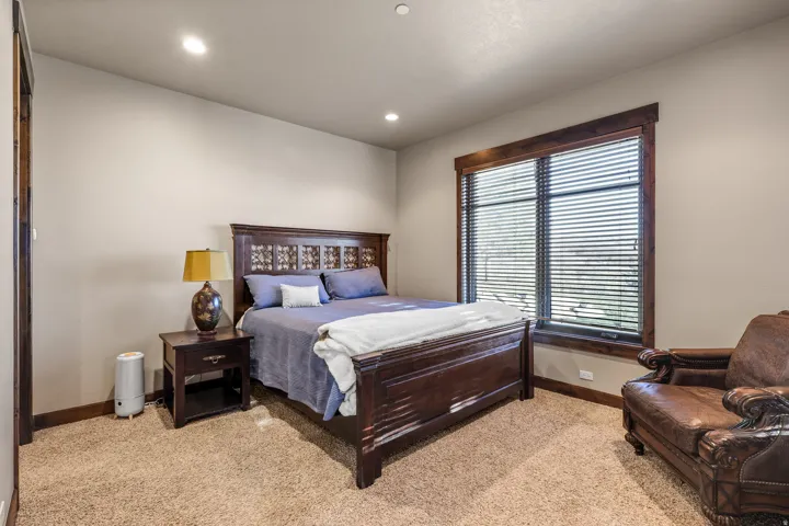 South bedroom. Recessed lighting, wood-trimmed window, wood-finish flooring, and wood-paneled door frame