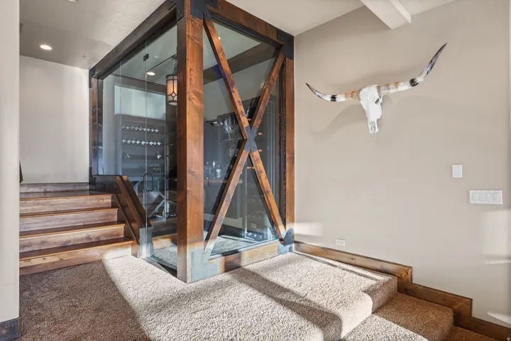 Glass-enclosed wine storage with wood beam framing