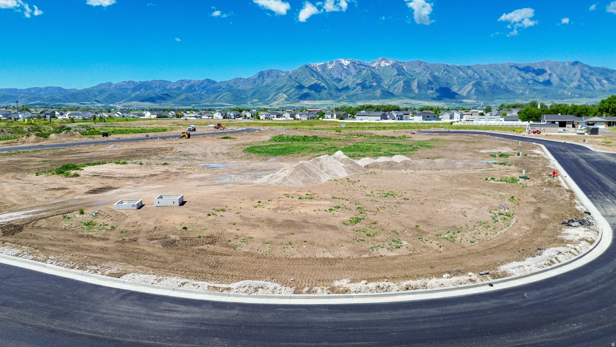 Expansive undeveloped lot with paved road frontage and mountain backdrop