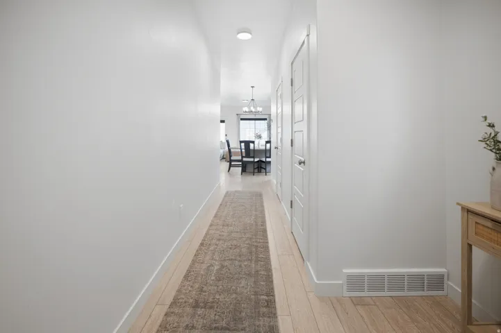 Hallway featuring wood-finish flooring and recessed lighting