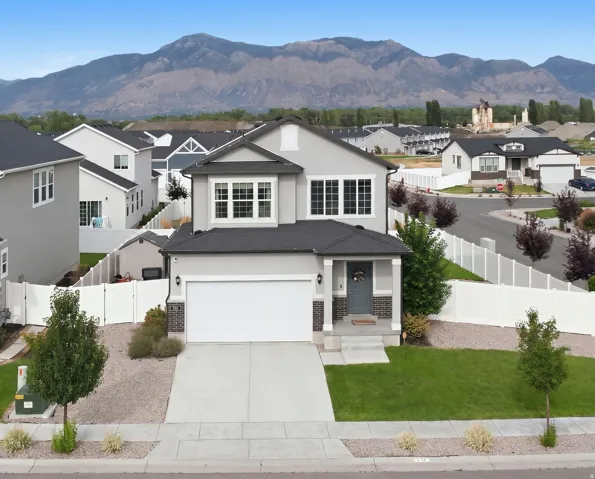 Contemporary two-story residence with a stucco exterior and dark shingle roof