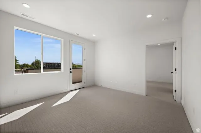 Bright family room featuring expansive glass doors and windows flooding the space with natural light