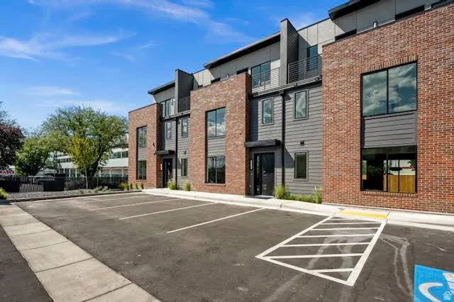 Contemporary multi-level exterior with a mix of brick and horizontal siding