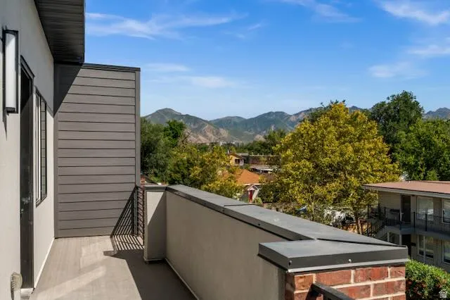 Private outdoor south-facing balcony featuring composite decking and a durable metal railing