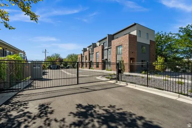 Gated entry with wrought iron fencing