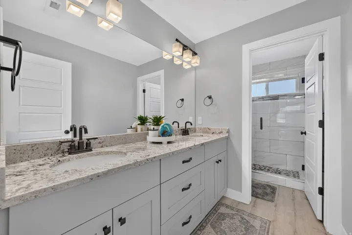 Double vanity with integrated sinks, light-toned countertop, and matte black fixtures