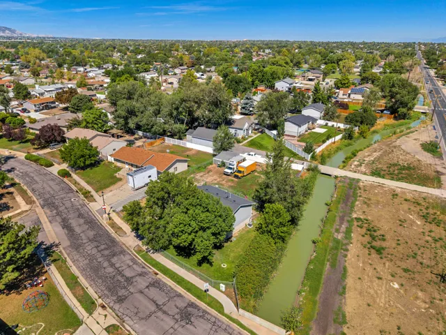 Residential neighborhood with mature trees, established homes, and an adjacent canal