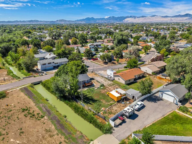 Expansive property featuring a detached garage, paved parking area, and a private fenced yard