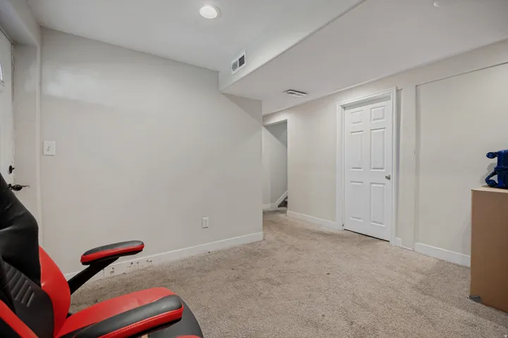 Recessed lighting, light-toned carpeting, white interior doors, and neutral wall finishes
