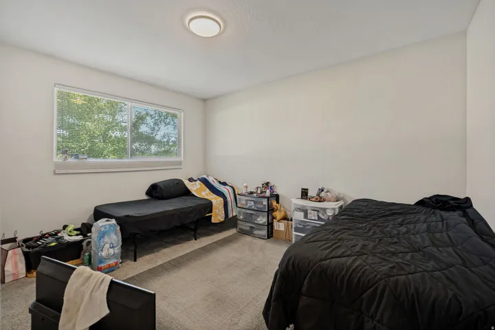 Recessed lighting, light-toned walls, and a window with blinds
