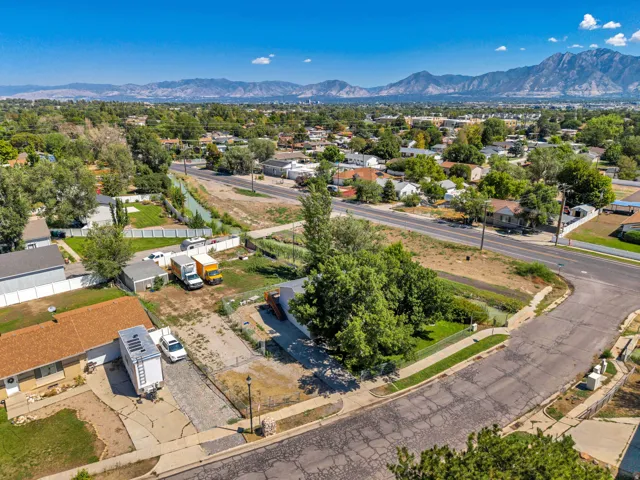 Expansive lot featuring mature trees, a detached storage shed, and direct street access