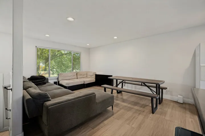 Recessed lighting, wood-finish flooring, and large windows