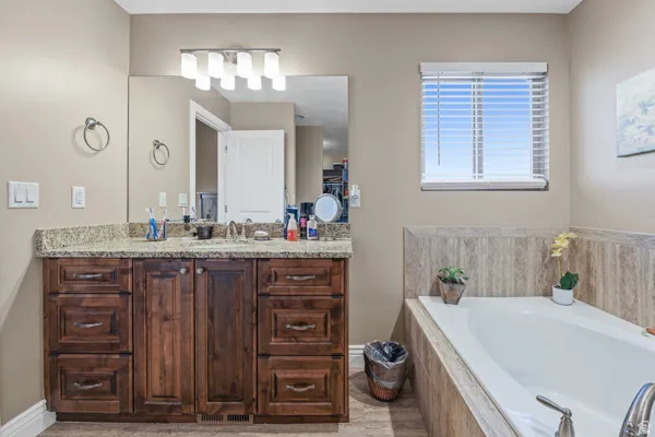 Master bathroom features double vanity with granite nd a large soaking tub.