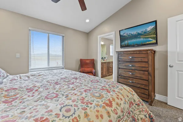 Vaulted ceiling with recessed lighting and a ceiling fan