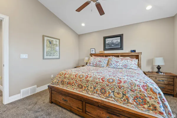 Vaulted ceiling with recessed lighting and a ceiling fan