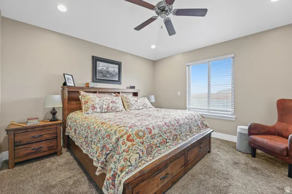 Master bedroom includes recessed ceiling lighting, ceiling fan, large window.