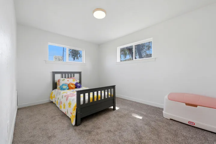 Plush carpeted flooring and white painted walls