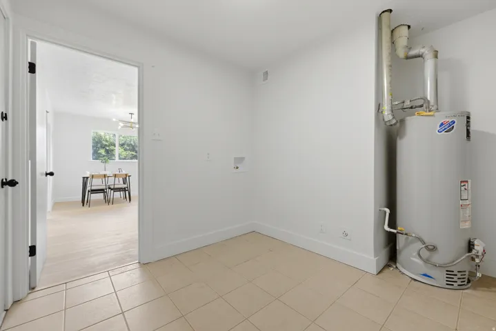 Utility area with tile flooring and appliance hookups
