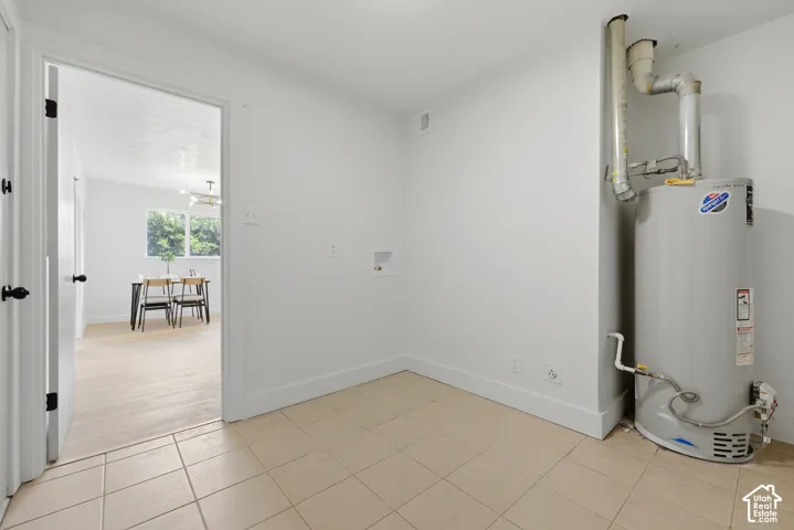 Utility area with tile flooring and appliance hookups