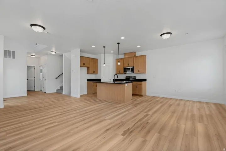 Open-concept living space with wood-finish flooring