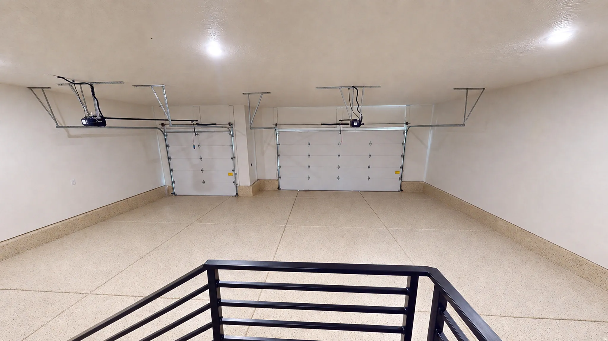 Two white sectional garage doors with automatic openers