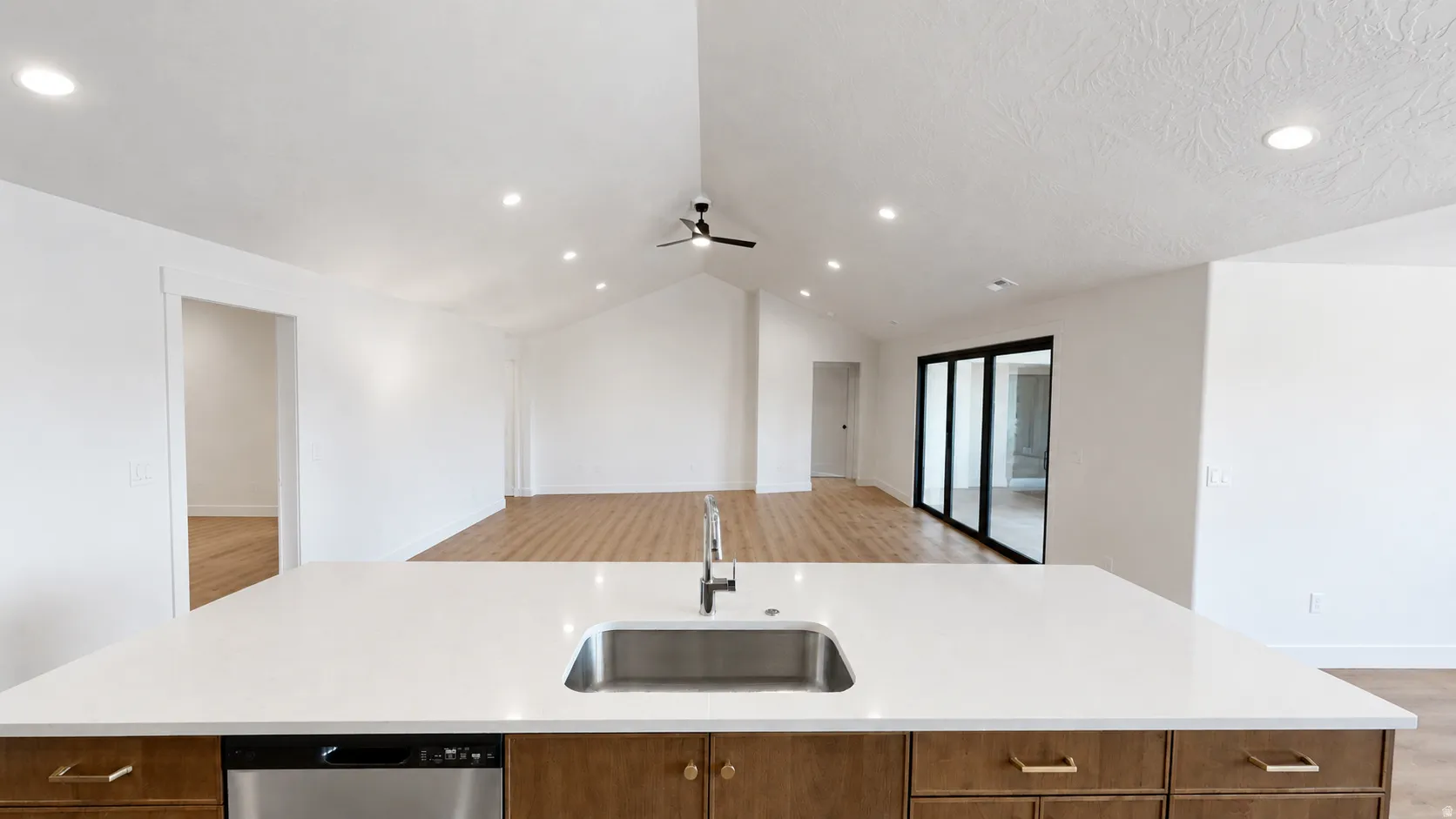 Kitchen island with a stainless steel sink and integrated dishwasher