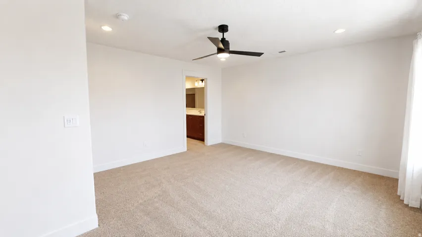 Carpeted flooring, recessed lighting, ceiling fan with light, and an open doorway