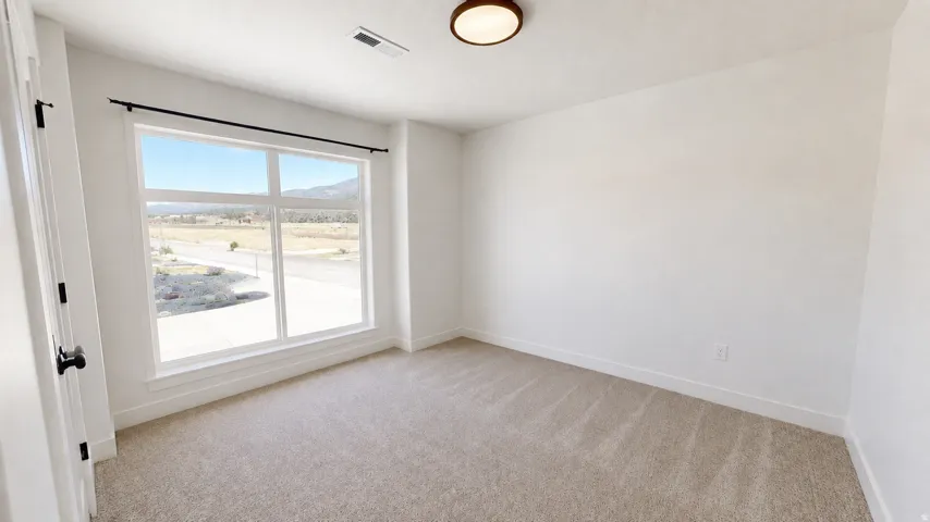 Spacious room with plush carpeting and a large window