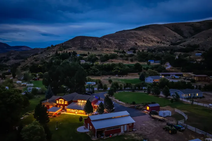 Expansive property featuring multiple structures, including a primary residence, a large barn, and additional outbuildings
