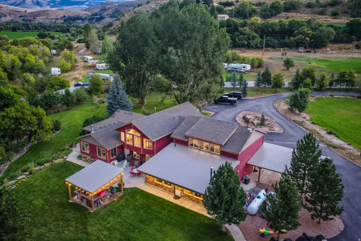 Red multi-level residence with gabled and metal roofing