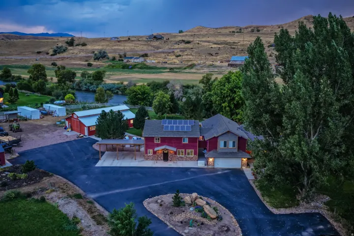 Two-story residence with a two-car garage, solar panels, and an attached carport
