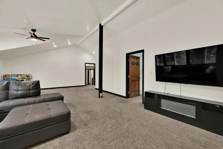 Vaulted ceilings with recessed lighting, ceiling fan, and carpeted flooring