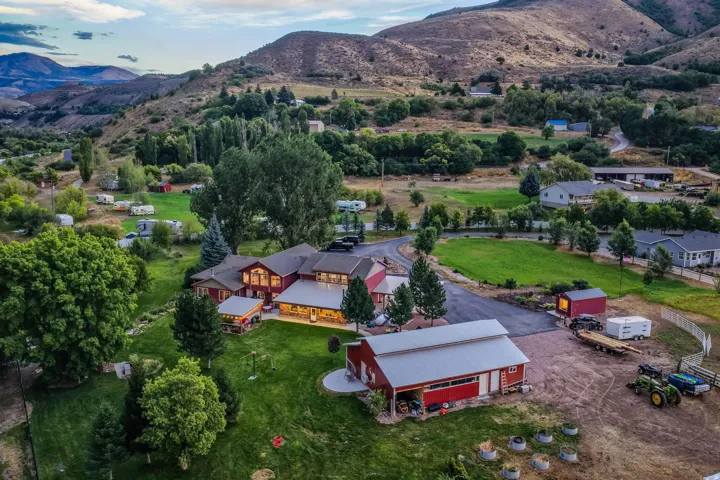 Expansive green lawns surrounding a large residence with a detached barn structure