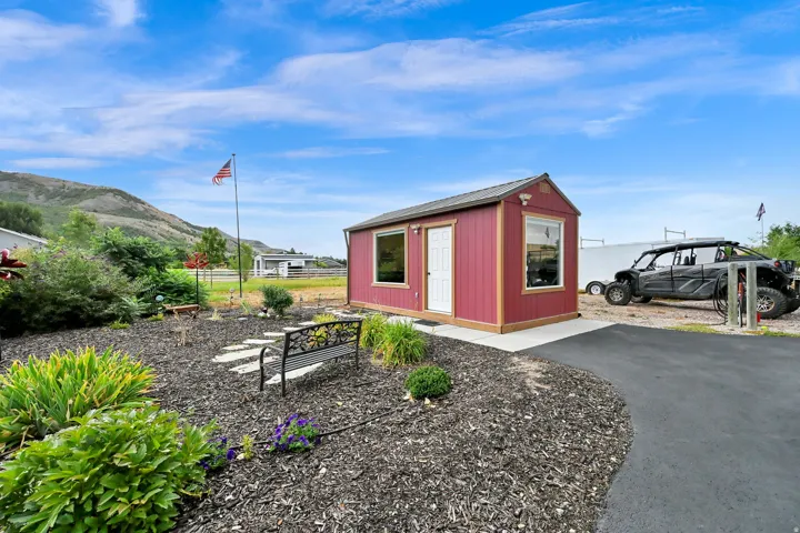 Red-sided outbuilding with white trim and multiple windows