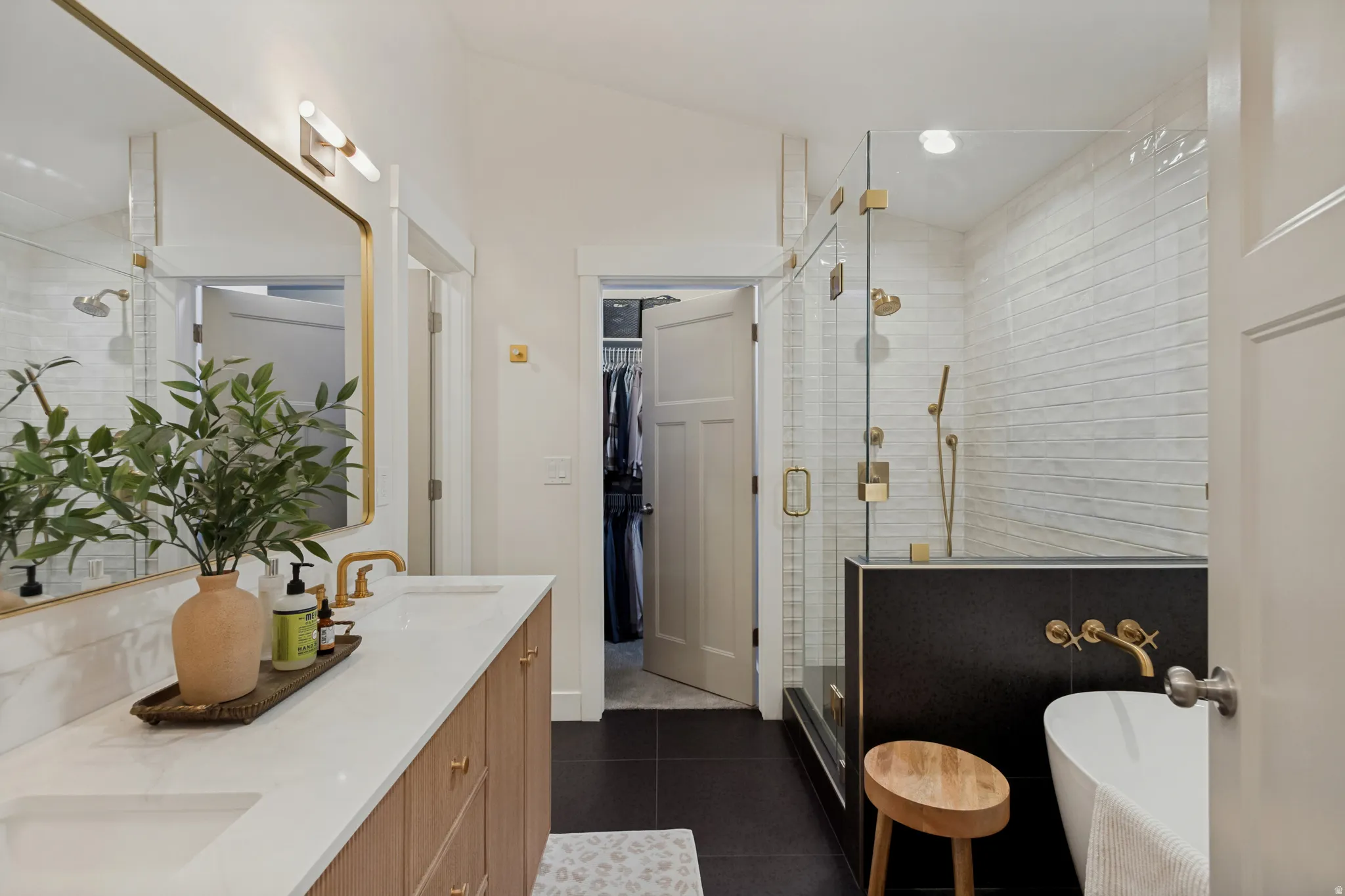 Dual vanity with white countertop and wood-finish cabinetry