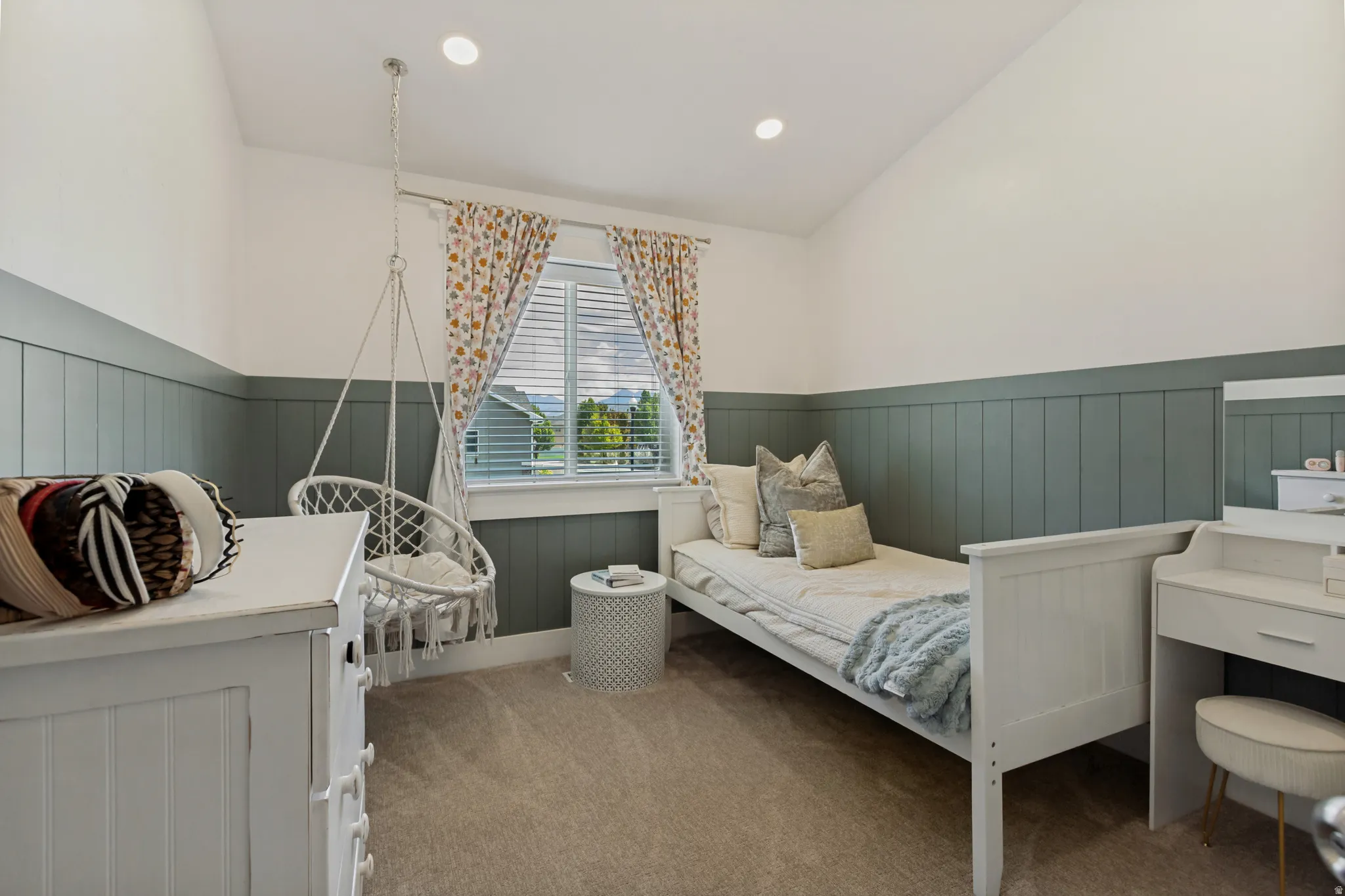 Vaulted ceilings with recessed lighting, integrated window blinds, and two-tone wall paneling
