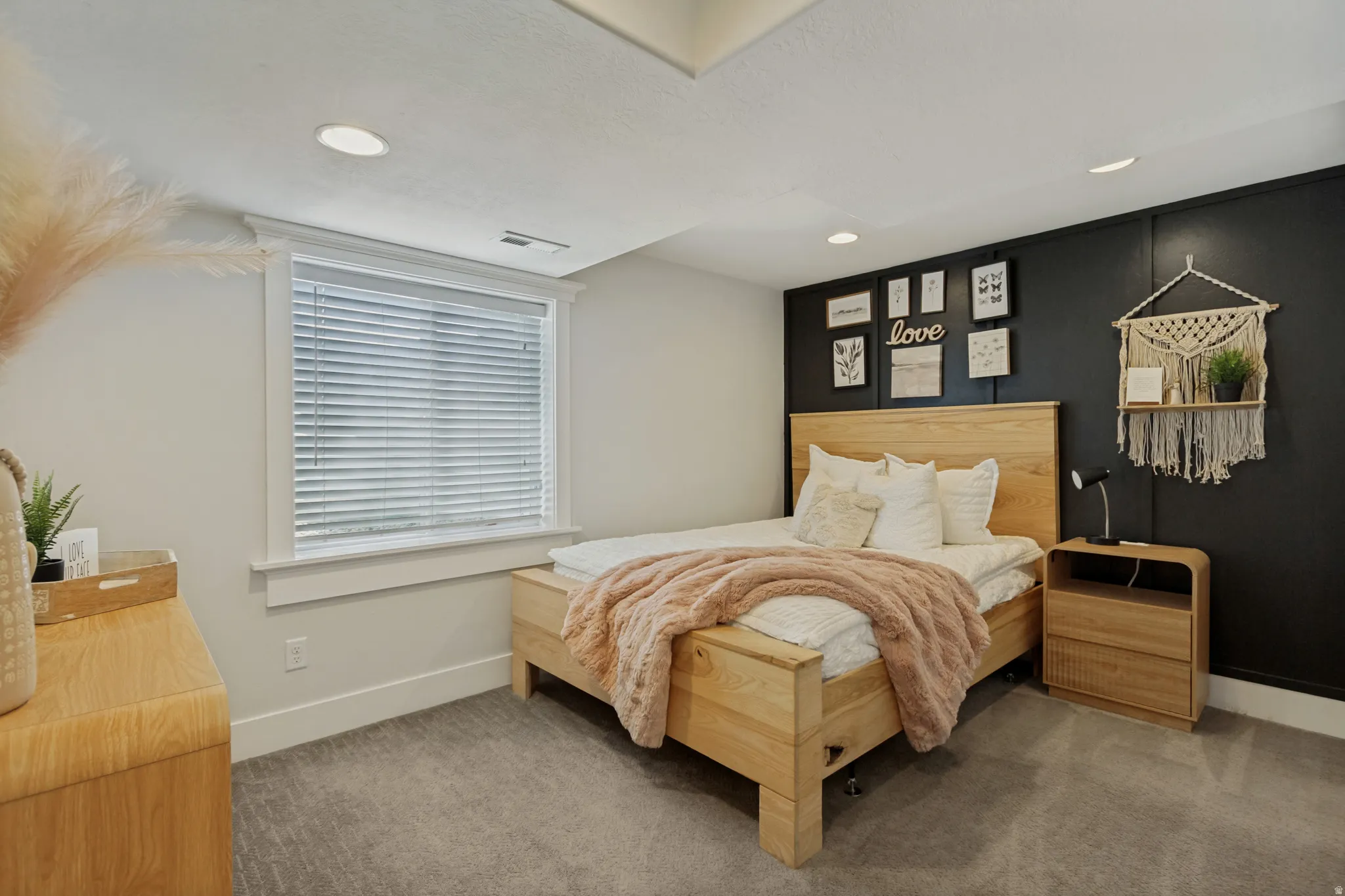 Recessed ceiling lighting, carpeted flooring, window with blinds, and contrasting accent wall