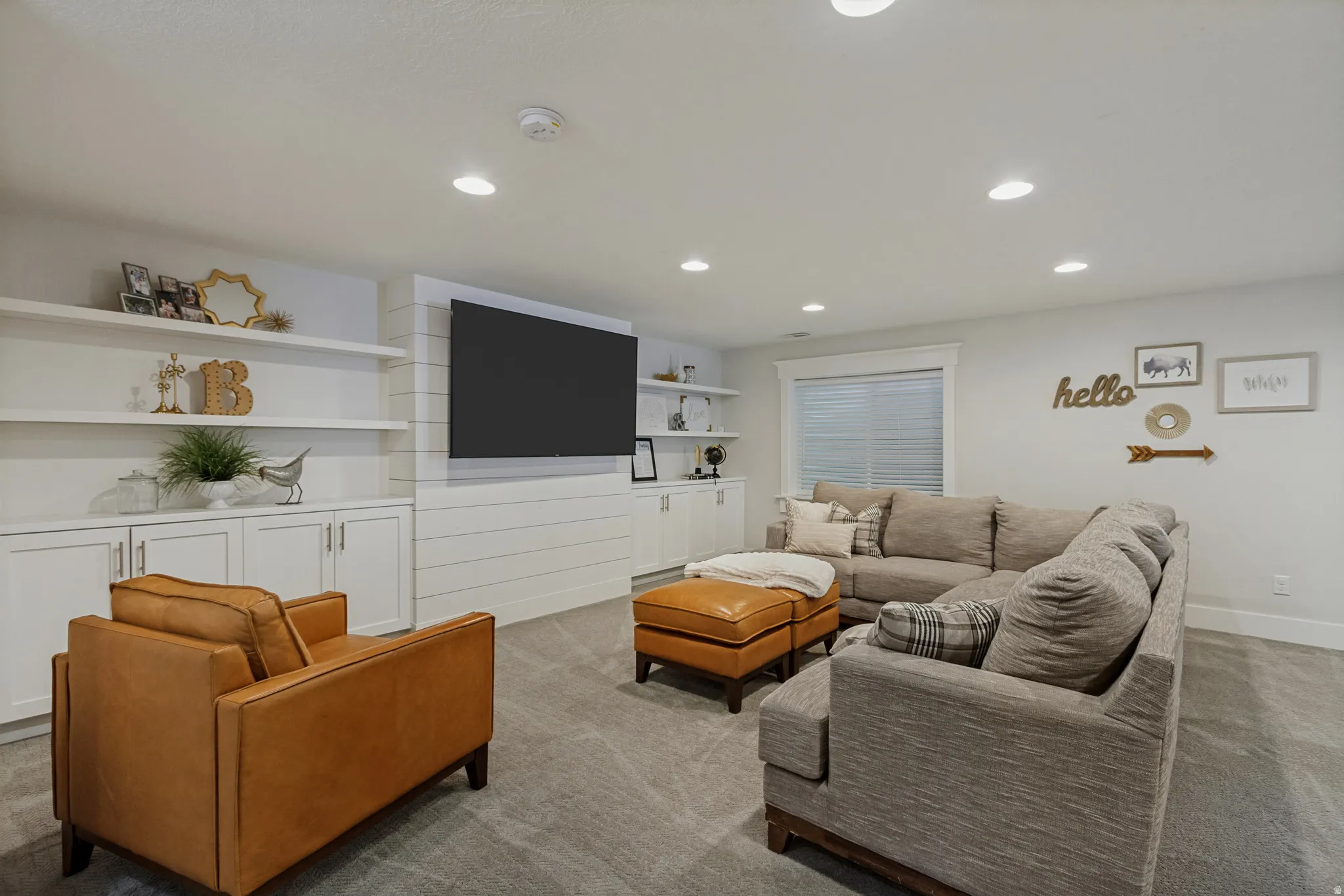 Recessed lighting illuminates the carpeted floor