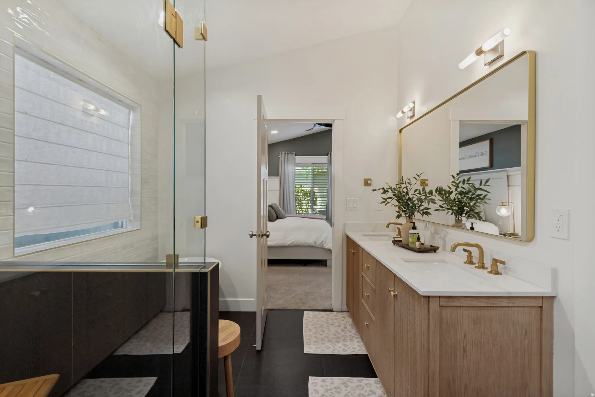 Dual vanity with light wood-finish cabinetry and white countertops