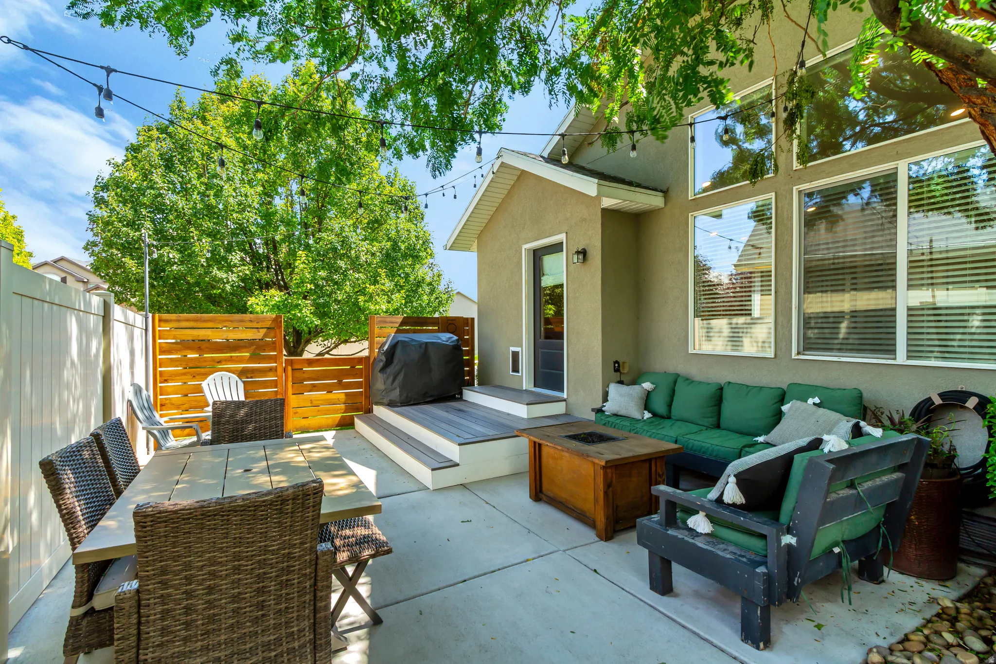 Concrete patio with an adjacent wood-finish deck