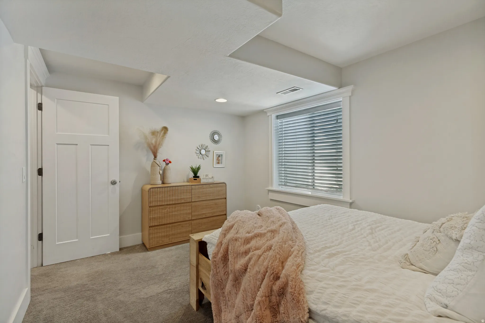 Recessed lighting, window with blinds, paneled interior door, and carpeted flooring